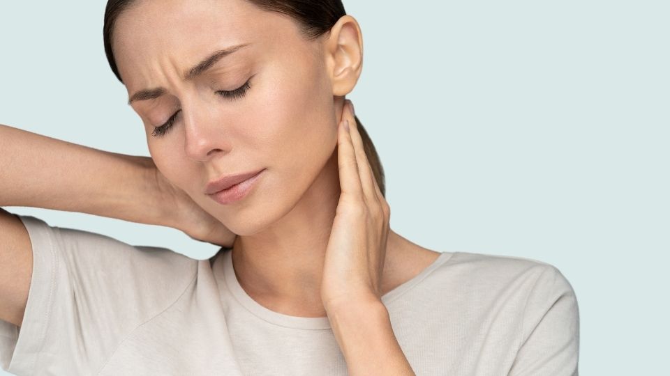 Woman In Pain Holding Her Neck